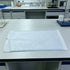 Self-sealing sterilization pouch laid flat on a laboratory bench