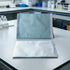 Self-sealing sterilization pouches displayed upright and flat on a laboratory bench